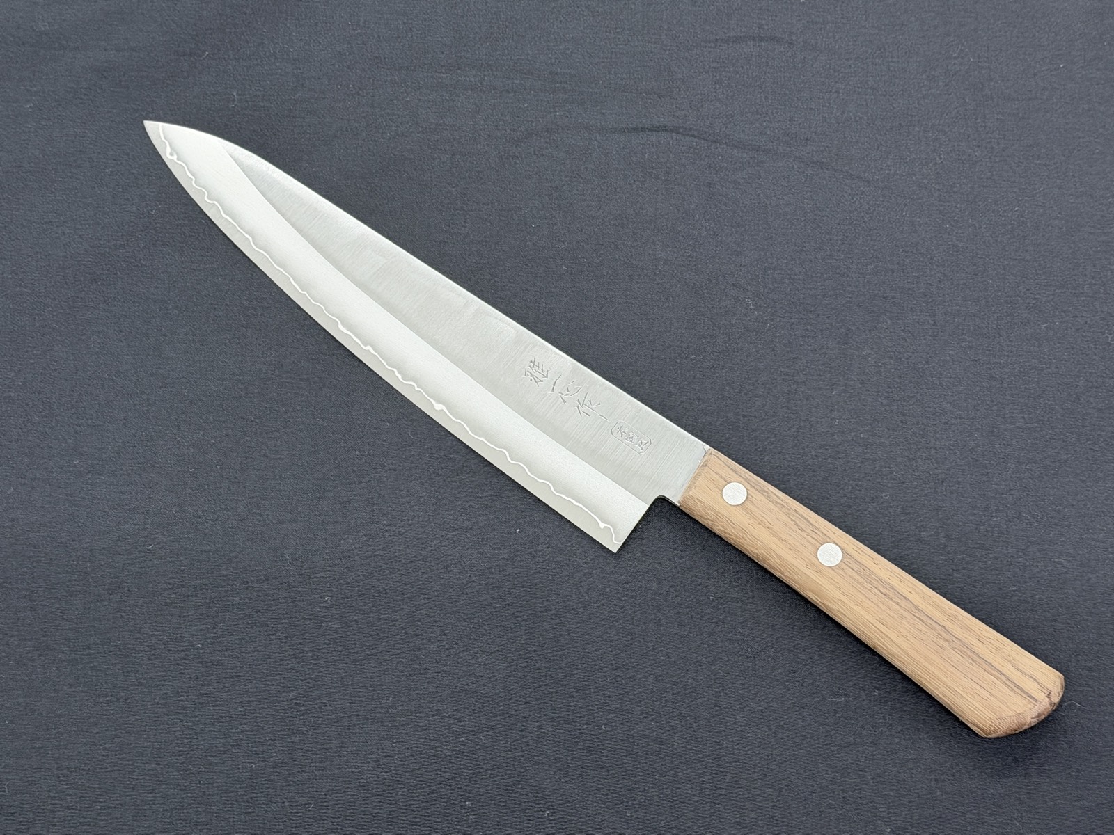 A santoku resharpened at Kiwami with the edge restored, with free sharpening for in-store buyers